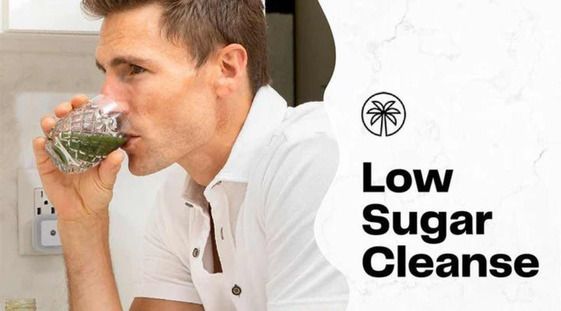 Man drinking green juice on a low sugar juice cleanse for weight loss